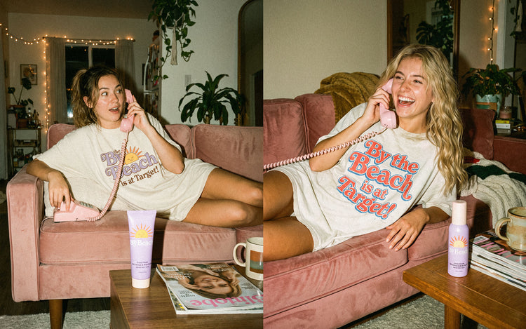 Two friends on pink sofas chatting on retro phones in By the Beach is at Target tees, with By the Beach SPF on the coffee tables